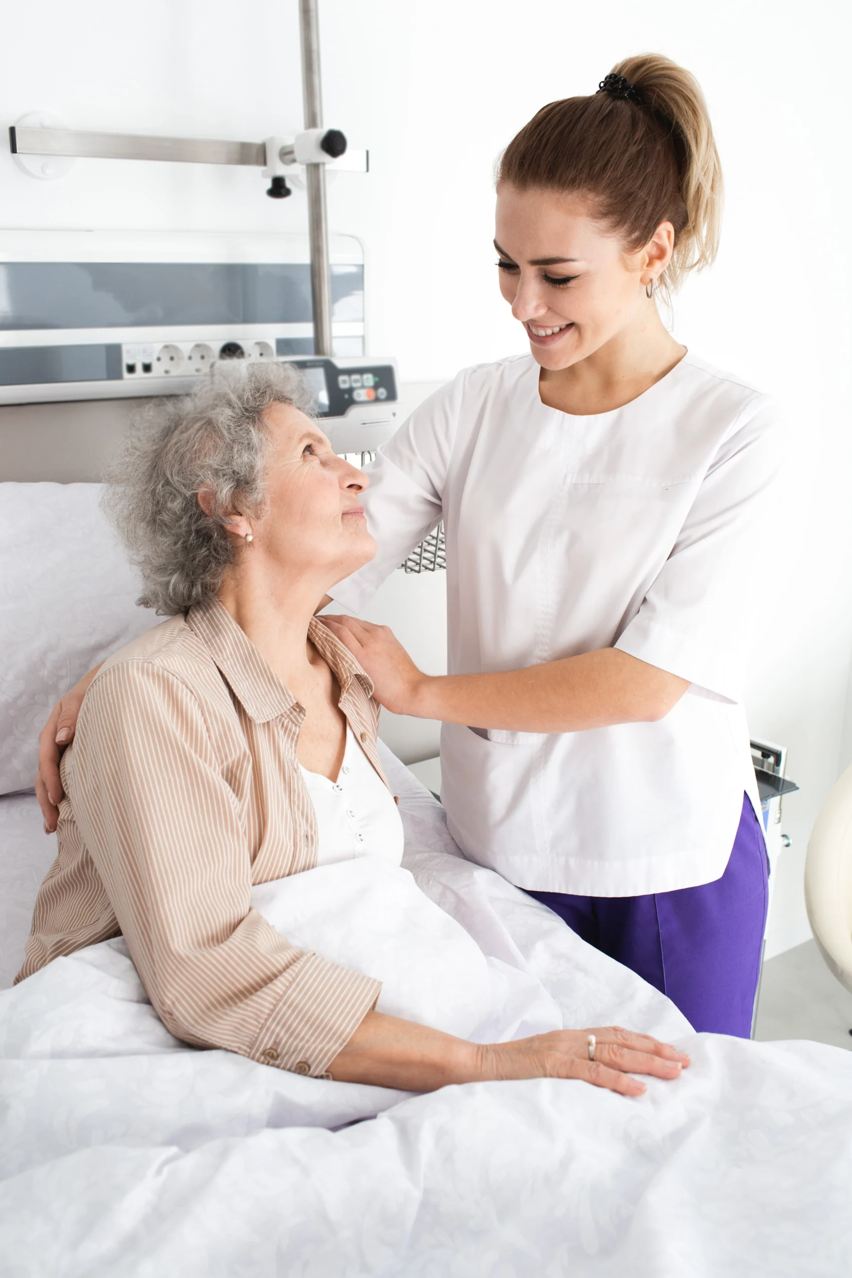 lady in bed looks up thankfully at caregiver